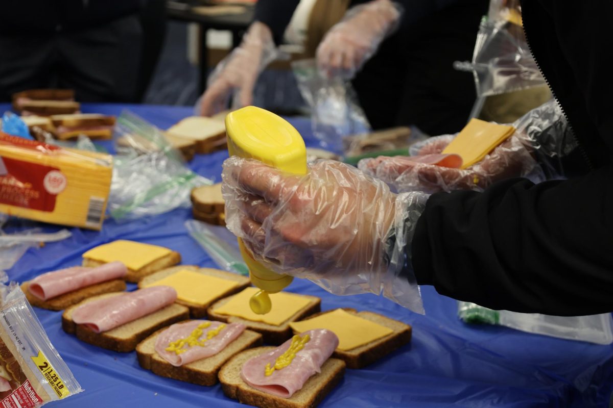 SMU Student making sandwiches at SMU Serves, a meal-packing event for impoverished families in the Dallas Community SMU, HT Ballroom, Dallas, TX. Sunday, Jan. 26, 2025. (Victoria Baeza)