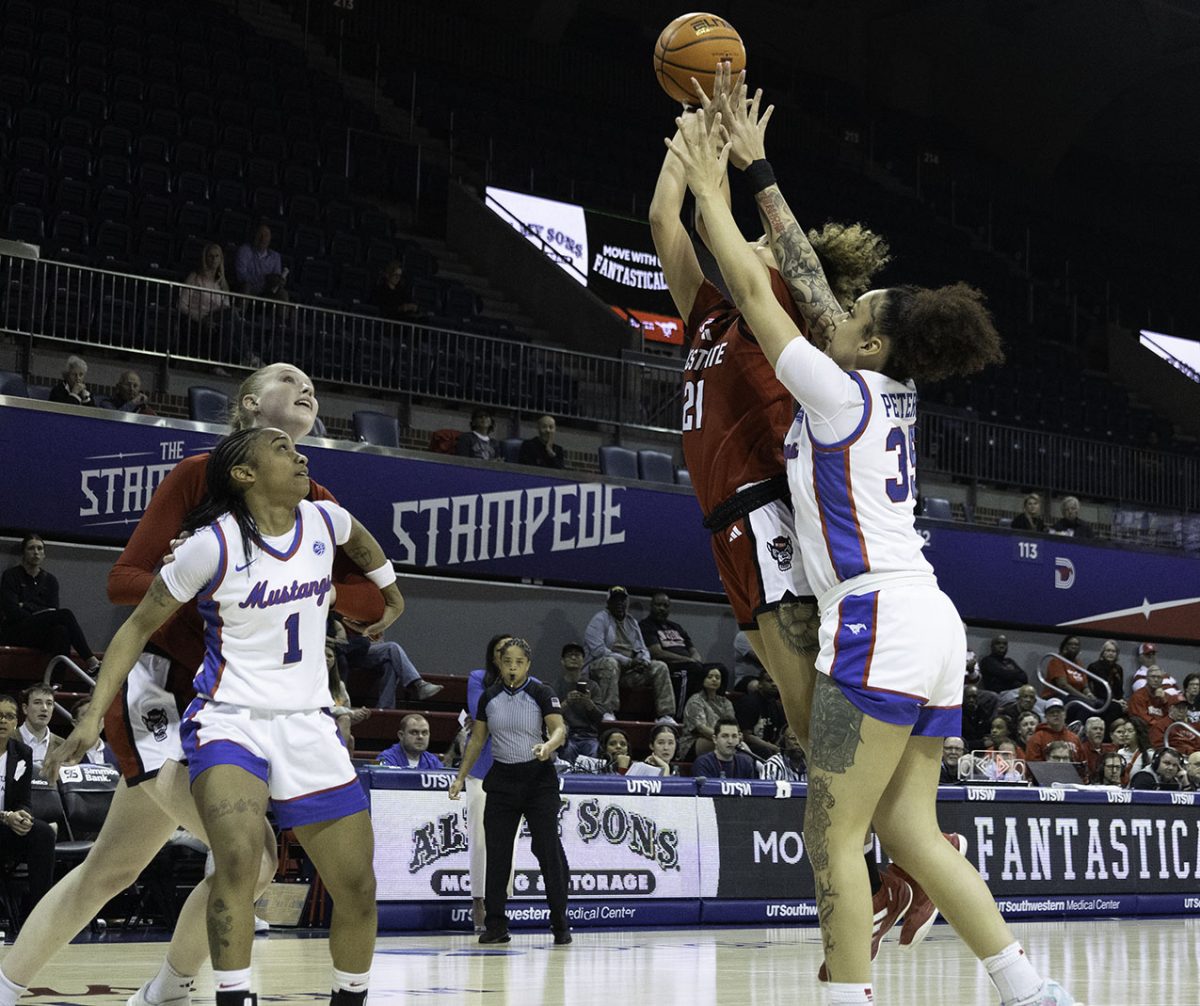 SMU basketball players Zanai Jones and TK Pitts block NC State players Tilda Trygger and Madison Hayes.