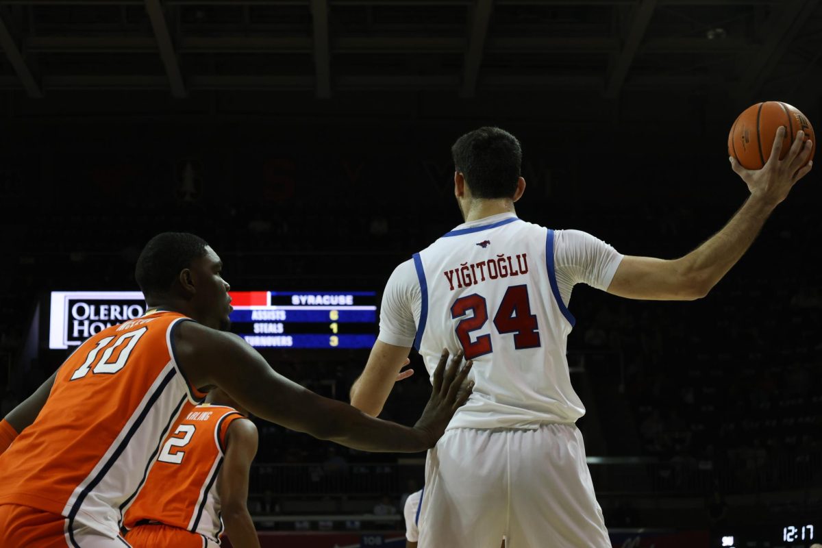 Samet Yiğitoğlu looks for a teammate to pass the ball to as he defends against a Syracuse player in Dallas, Texas, on March 4, 2025. (SMU: Chloe Casdorph)