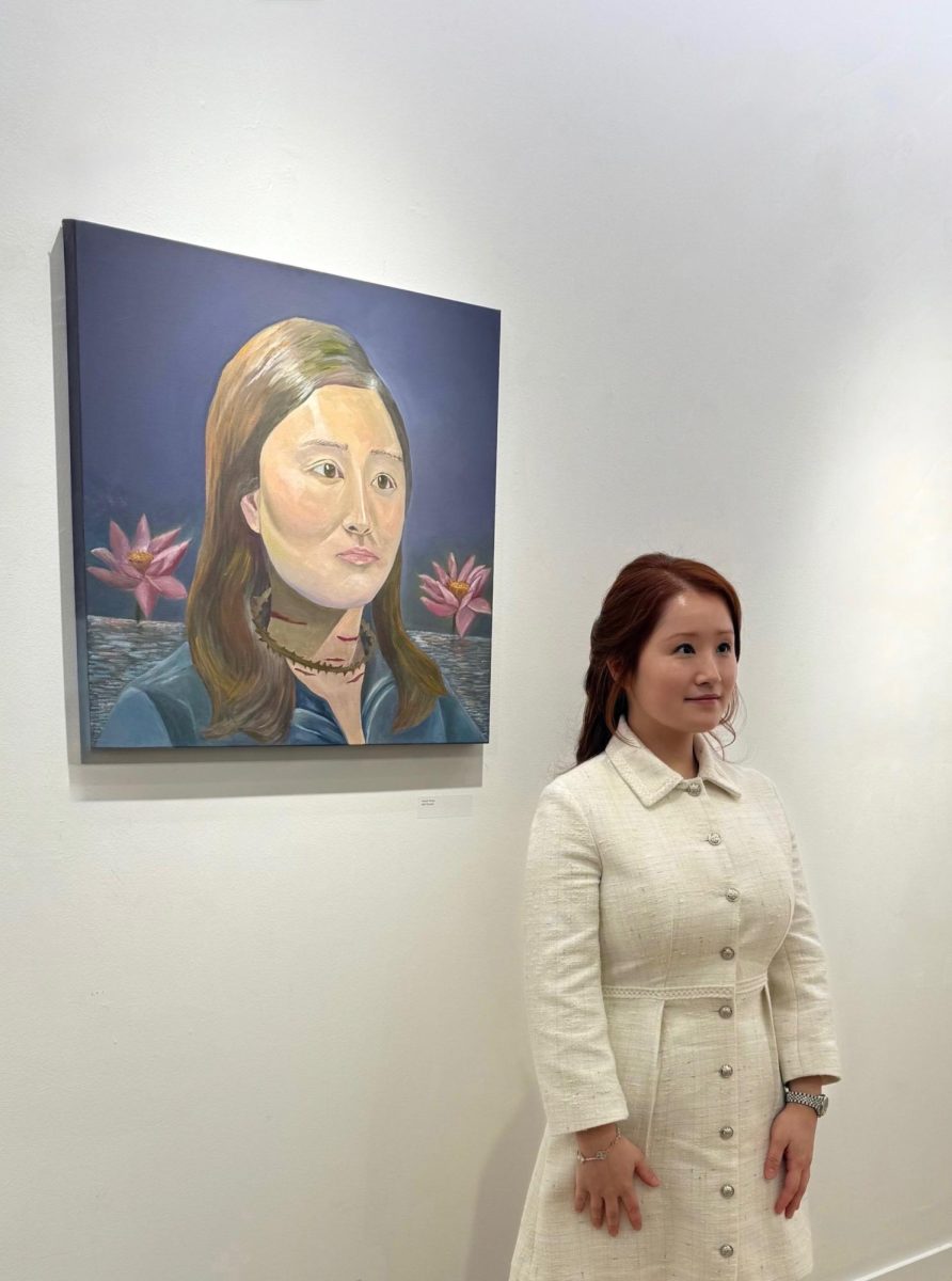 SMU junior Areum Finley stands by her portrait "The Inner Lotus" at The exhibition The Space Between at Meadows School of Arts on Feb 21. 