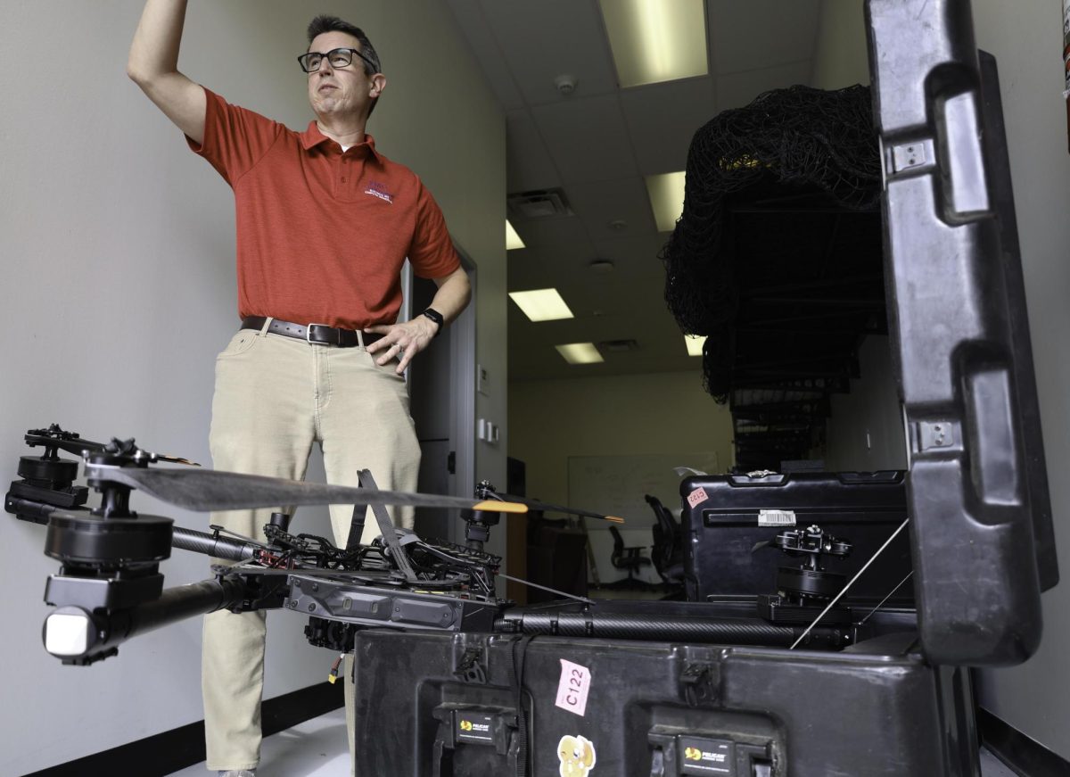 Joe Camp pulls out one of his larger drones as he begins to work on it in his lab.