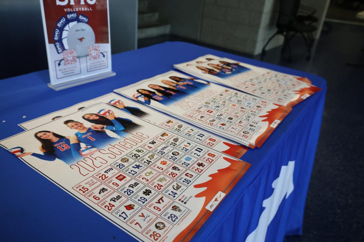 Various posters of the SMU volleyball season schedule for the 2025 season in Moody Coliseum.