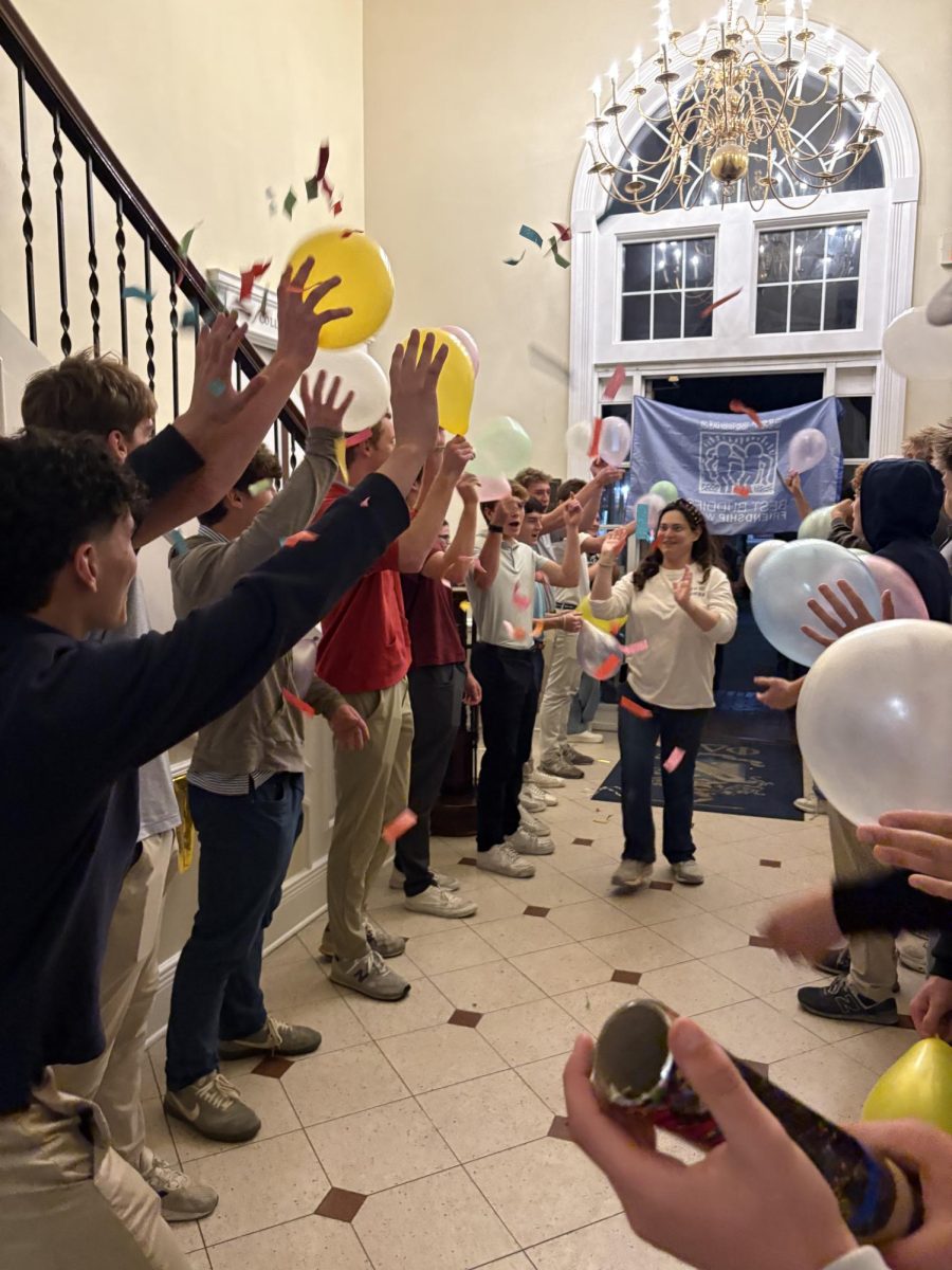 Ashley Chaffin high-fives members of Phi Delta Theta as she runs to her buddy, Charlotte Smith.