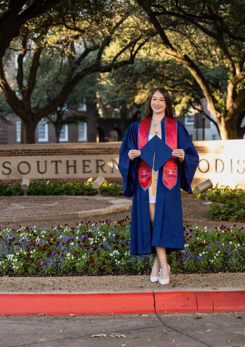 Briseida Hernandez takes her graduation photos in preparation for the upcoming ceremony. 