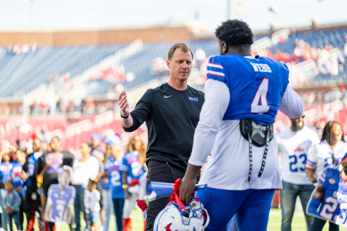 Rhett Lashlee greets defensive tackle Terry Webb on Senior Day, one of the 30 seniors playing their final game at Ford Stadium.