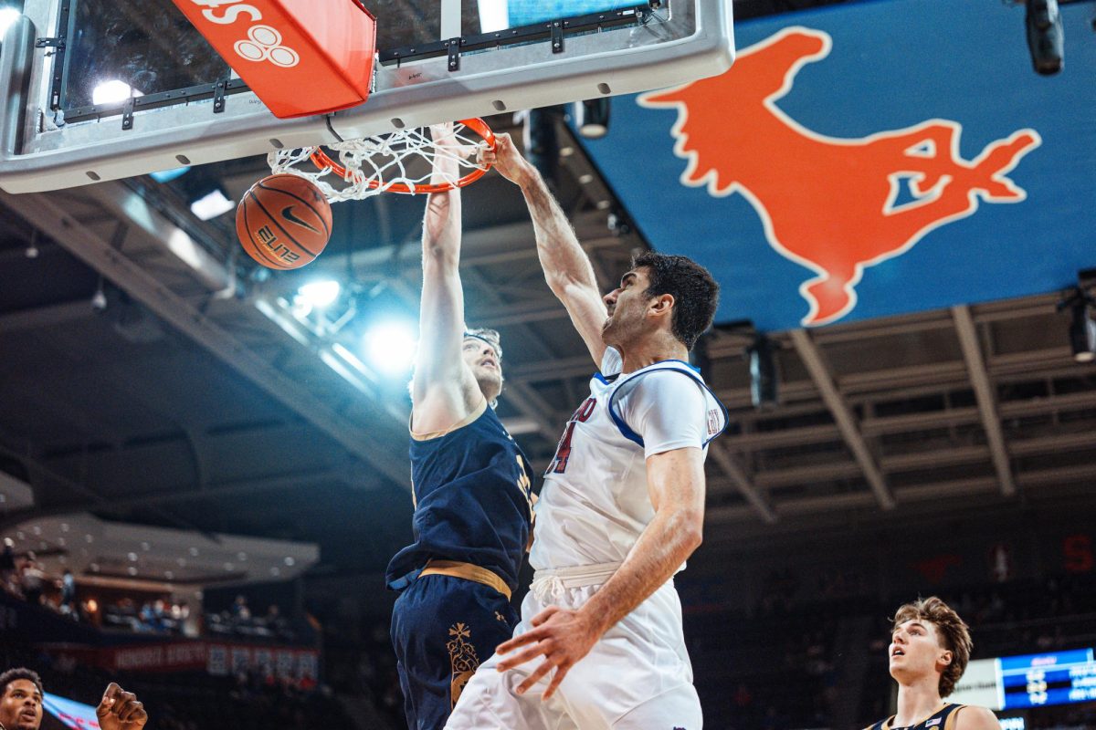 Samet Yiğitoğlu throws down a dunk on a Notre Dame defender in Dallas, TX, on Feb. 10, 2026.
