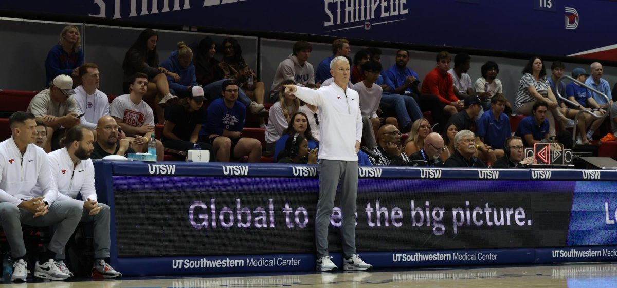 Head men's basketball coach Andy Enfield stands courtside, yelling plays to the players on the court in Dallas, Texas, on Oct. 25, 2025.