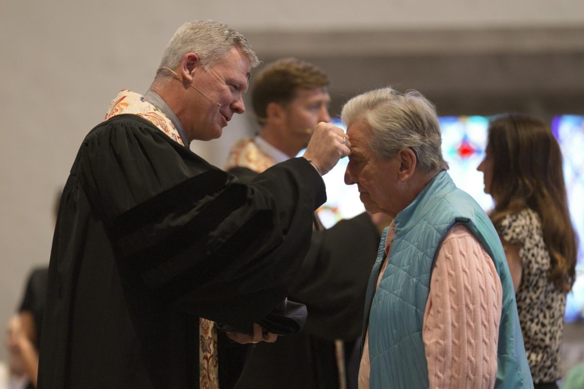 Rev. Dr. Abe Smith applying a cross of ashes to an attendee's head at Highland Park Methodist Church in University Park, TX, on Feb. 18, 2026.