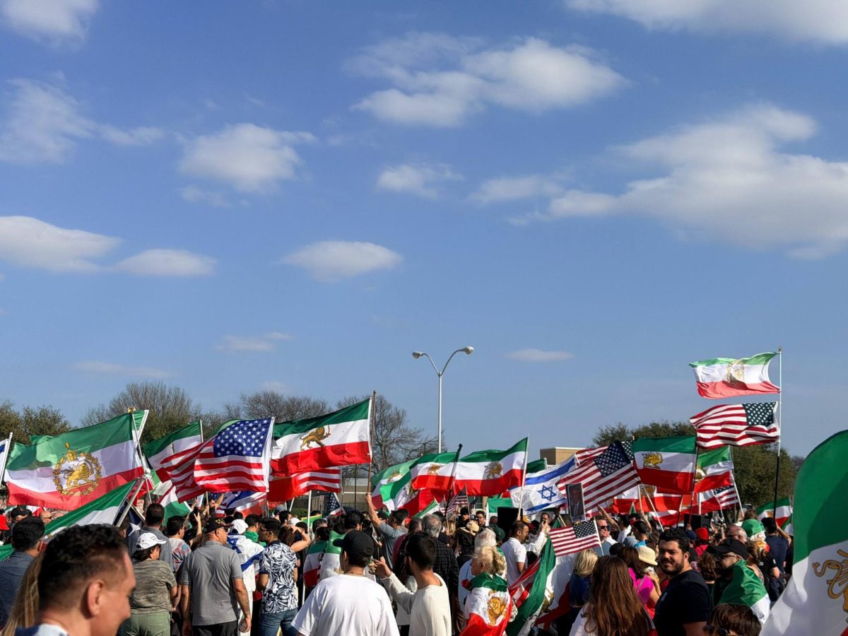 Demonstrators hold up U.S., Iranian, and Israeli flags while gathering in Plano, TX, on Feb. 29, 2026. 