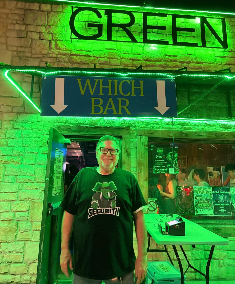 Shannon McKinnon, owner of The Green Elephant, stands in front of his bar on a “Homebar Thursday” night.