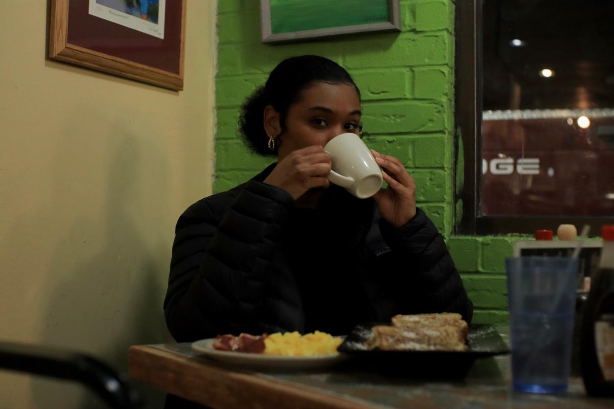 Aijah Bailey-Ray enjoys her late-night breakfast with coffee while studying at Cafe Brazil. 