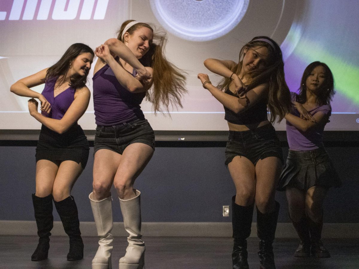SMU’s K-pop cover team, Vektor, dances onstage at Hughes-Trigg Auditorium.