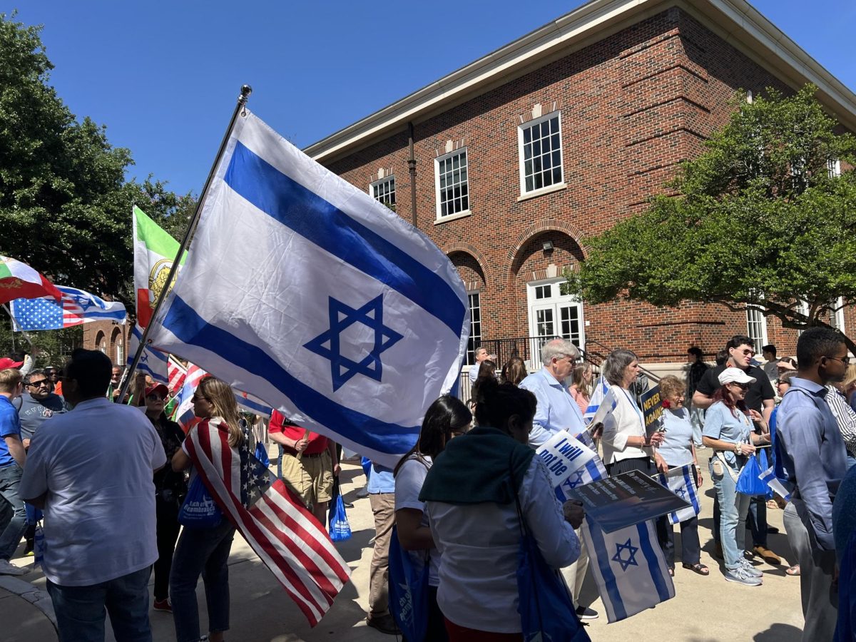 People hold up an Israeli flag to show support for the Jewish community during the March of Remembrance on April 19, 2026, outside Hughes-Trigg Student Center. Members of the Dallas-Fort Worth community gathered for the rally, which was led by Rabbi Coretz and organized in honor of Holocaust Remembrance Day.